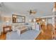 Spacious living room with a mirror feature, wooden flooring, and an open layout to the kitchen at 5275 S Atlantic Ave # 506, New Smyrna Beach, FL 32169