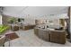 Large lounge area furnished with rattan seating, a plant and a view of a breakfast bar at 5275 S Atlantic Ave # 506, New Smyrna Beach, FL 32169