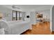 Bright main bedroom with balcony access and ocean views; hardwood flooring throughout at 5275 S Atlantic Ave # 506, New Smyrna Beach, FL 32169