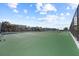 Community tennis court with fenced perimeter and palm tree views at 5275 S Atlantic Ave # 506, New Smyrna Beach, FL 32169