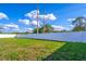 Spacious backyard enclosed by a white fence and lush greenery is perfect for outdoor activities and relaxation at 554 Appleton Pl, Oviedo, FL 32765