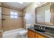 Stylish bathroom features a tiled shower/tub combination, modern vanity, granite countertop, and decorative accents at 554 Appleton Pl, Oviedo, FL 32765