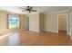Spacious bedroom with natural light, ceiling fan, and wood flooring at 554 Appleton Pl, Oviedo, FL 32765
