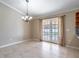Dining area with views of pool, ceramic tile flooring and modern chandelier at 554 Appleton Pl, Oviedo, FL 32765