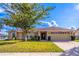 Charming single-story home showcasing a well-manicured lawn and attached two car garage at 554 Appleton Pl, Oviedo, FL 32765