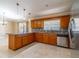 Charming kitchen offers stainless appliances, a stylish backsplash and a granite countertop at 554 Appleton Pl, Oviedo, FL 32765
