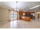 Open kitchen and dining area feature island, wooden cabinets and stainless steel appliances at 554 Appleton Pl, Oviedo, FL 32765