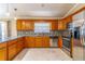 Well-lit kitchen has stainless appliances and a stylish backsplash at 554 Appleton Pl, Oviedo, FL 32765
