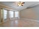 Bright living room featuring ceramic tile flooring, ceiling fan, and large windows at 554 Appleton Pl, Oviedo, FL 32765