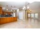 Open-concept living space featuring kitchen with island and tile flooring at 554 Appleton Pl, Oviedo, FL 32765