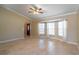 Open concept living room with ceramic tile flooring, ceiling fan, and arched doorway at 554 Appleton Pl, Oviedo, FL 32765