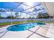 Sparkling pool in screened enclosure, surrounded by a well-maintained patio, offers a private outdoor oasis at 554 Appleton Pl, Oviedo, FL 32765