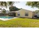 A pristine backyard showcasing a swimming pool, screened-in patio, and green grass at 5547 Garden Grove Cir, Winter Park, FL 32792