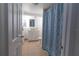Bathroom featuring vanity sink, white cabinets, and shower with blue curtain at 5547 Garden Grove Cir, Winter Park, FL 32792