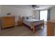 Bedroom with natural light, ceiling fan, and wood-look laminate flooring throughout at 5547 Garden Grove Cir, Winter Park, FL 32792