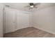 Bedroom with wood-look laminate flooring, closet, and ceiling fan at 5547 Garden Grove Cir, Winter Park, FL 32792