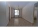 Bright dining room boasts neutral tile flooring and an elegant chandelier light fixture at 5547 Garden Grove Cir, Winter Park, FL 32792