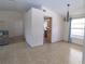 Open concept dining area featuring neutral tile flooring and a decorative chandelier light fixture at 5547 Garden Grove Cir, Winter Park, FL 32792