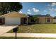 Charming single Gathering home featuring a well-manicured front yard and solar panels at 5547 Garden Grove Cir, Winter Park, FL 32792