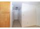 Hallway with tile flooring, white walls, and overhead lighting leading to bedrooms at 5547 Garden Grove Cir, Winter Park, FL 32792