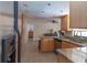 Kitchen with tile floors and granite countertops featuring an eat-in bar area at 5547 Garden Grove Cir, Winter Park, FL 32792