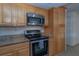 This kitchen features stainless steel appliances, granite countertops, and light wood cabinets at 5547 Garden Grove Cir, Winter Park, FL 32792