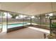 The screened-in lanai offers views of the beautiful swimming pool and green backyard at 5547 Garden Grove Cir, Winter Park, FL 32792