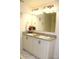 Bathroom featuring double sinks, granite counters, and framed seashell art at 5897 Soter Ln, Windermere, FL 34786