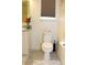 Bathroom featuring a toilet, grey floors, and a striped bath mat at 5897 Soter Ln, Windermere, FL 34786