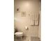 Bathroom featuring neutral walls, a standard toilet, a towel rack, and shower with patterned curtain at 5897 Soter Ln, Windermere, FL 34786