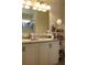 Bright bathroom featuring double sinks with granite countertop and decorative fixtures and a framed mirror at 5897 Soter Ln, Windermere, FL 34786