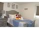Cozy bedroom with a comfortable bed and framed art pieces creating a relaxed atmosphere at 5897 Soter Ln, Windermere, FL 34786