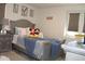 Cozy bedroom with a full-sized bed, soft gray tones, and plenty of natural light at 5897 Soter Ln, Windermere, FL 34786