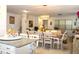 Dining area with a long wood table, white chairs, and an open layout connecting to the living room at 5897 Soter Ln, Windermere, FL 34786