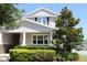 Two-story home boasts mature trees, lush landscaping, and a well-maintained lawn enhancing its curb appeal at 5897 Soter Ln, Windermere, FL 34786
