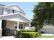 Inviting home exterior showcasing a well-manicured lawn, lush landscaping, and a charming front porch at 5897 Soter Ln, Windermere, FL 34786