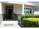 Inviting front porch with decorative plants and a charming welcome mat, creating a warm entrance at 5897 Soter Ln, Windermere, FL 34786