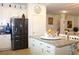 Kitchen with stainless steel appliances, a granite island, and access to the dining area and staircase at 5897 Soter Ln, Windermere, FL 34786