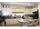 Bright kitchen features white cabinets, modern appliances, granite countertops, and an island with seating at 5897 Soter Ln, Windermere, FL 34786