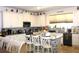 Open kitchen featuring white cabinets, granite counters, stainless appliances, island seating, and stylish decor at 5897 Soter Ln, Windermere, FL 34786