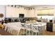Bright kitchen and dining area featuring white cabinets, granite counters, and stainless-steel appliances at 5897 Soter Ln, Windermere, FL 34786