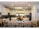 Spacious kitchen connected to the dining area features white cabinets, granite counters, and modern appliances at 5897 Soter Ln, Windermere, FL 34786