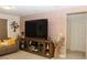 Cozy living room featuring a large screen TV, textured wall, and stylish decor at 5897 Soter Ln, Windermere, FL 34786