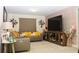 Cozy living room with a sectional sofa, large TV, and textured accent wall at 5897 Soter Ln, Windermere, FL 34786