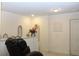 Bright loft area featuring a massage chair, neutral decor, and white walls at 5897 Soter Ln, Windermere, FL 34786