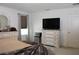 Serene main bedroom with dressers, TV, and a mini fridge at 5897 Soter Ln, Windermere, FL 34786