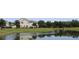 Scenic view of townhomes reflected in the serene community pond and green spaces at 5897 Soter Ln, Windermere, FL 34786
