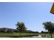 Scenic pond view within the community featuring lush green spaces and buildings at 5897 Soter Ln, Windermere, FL 34786