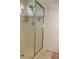 A glass enclosed walk-in shower with handheld shower head and built-in storage at 5897 Soter Ln, Windermere, FL 34786