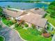 Aerial view of condo community offers lush landscaping, a community pool, and lake views at 650 Woodridge Drive, Fern Park, FL 32730
